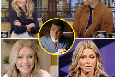 “KELLY RIPA IN HOT WATER AFTER SHOCKING ON-AIR REVELATION—‘I’M BEING MONITORED 24/7!’ WHAT HAPPENED NEXT LEFT EVERYONE STUNNED!”  LIVE ON AIR, Kelly Ripa dropped a bombshell that left the studio in complete silence. While discussing her day-to-day life, Kelly casually revealed, “I’m being monitored 24/7.” The chilling comment came out of nowhere, sparking an immediate firestorm.  What started as a simple discussion about her routine quickly turned into a bizarre revelation, as Kelly claimed to be “under house arrest”—a shocking statement that left both her co-hosts and viewers scrambling for answers.  What’s really going on behind the scenes? Is Kelly truly under surveillance, or is there something far darker at play? Fans and critics alike are in complete shock, with some questioning whether Kelly’s words were a slip-up or a strategic reveal.  What does this shocking admission mean for Kelly Ripa, and why is the internet blowing up over her comment? The mystery deepens, and the questions keep piling up.  Click below to uncover the full story behind this mind-boggling admission and why it’s shaking up the entertainment world.